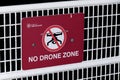 Red Warning Sign `No Drone Zone` found on the Canada Place fence at the Port of Vancouver