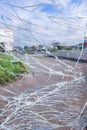 Vandalised Broken bus stop in the city. Dangerous, crashed tempered glass pieces on ground Royalty Free Stock Photo