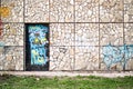 Vandalized Door and Stone Wall