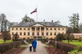 Vandzene manor, mother with child, park and latvian flag on a autumn day, Talsi, Latvia