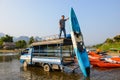 Vang Vieng, Laos - February 17, 2016 : : Many kayaks tied to the dock and waiting for adventure on sunny day