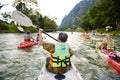 Vang Vieng, Laos - November 13, 2014 : Unidentified tourists kayaking along the Nam Song river in Vang Vieng town