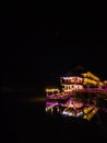 Beautiful view of nam song river with riverside restaurant and the mountain in the night at Vangvieng city Lao. Royalty Free Stock Photo