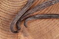 Vanilla beans on wooden board, closeup photo from above