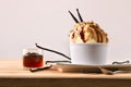 Vanilla and caramel ice cream cup decorated with pods Royalty Free Stock Photo