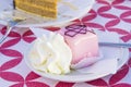 Vanilla and chocolate cupcakes covered with strawberry icing and whipped cream Royalty Free Stock Photo