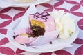 Vanilla and chocolate cupcakes covered with strawberry icing and whipped cream Royalty Free Stock Photo