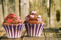 Vanilla cupcake with chocolate topping. Old wooden background. Royalty Free Stock Photo