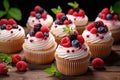 Vanilla cupcakes with cream and berries Royalty Free Stock Photo