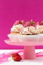 Vanilla cupcakes decorated strawberries on a pink backgground Royalty Free Stock Photo