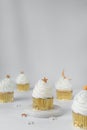 vanilla cupcakes with white buttercream and a gold star