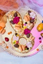Vanilla Easter cake, in easter bunny shape, decorated with flowers and macaroons