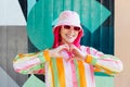 Vanilla Girl. Kawaii vibes. Candy colors design. Young woman with pink hair and sun glasses in bucket hat and multicolor