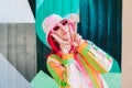 Vanilla Girl. Kawaii vibes. Candy colors design. Young woman with pink hair and sunglasses in Bucket hat and multicolor