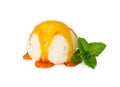 Vanilla ice cream ball with caramel syrup and fresh mint isolate