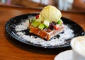 Vanilla ice cream with berries, strawberries, blueberries, raspberries, apple on waffle with powdered sugar. Summer food concept Royalty Free Stock Photo