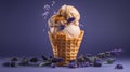 Vanilla ice cream with caramel sauce and lavender flowers in waffle cone on purple background