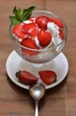 Vanilla ice cream with chopped strawberries and a mint leaf Royalty Free Stock Photo