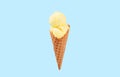 Vanilla ice cream cone on blue faded pastel color background. Royalty Free Stock Photo