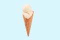 Vanilla ice cream cone on blue faded pastel color background. Royalty Free Stock Photo