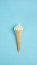 Vanilla ice cream cone on blue faded pastel color background. Vanilla ice cream in wafer cup Royalty Free Stock Photo