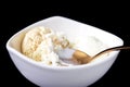 Vanilla ice cream and copper spoon in the white bowl isolated on black. Royalty Free Stock Photo