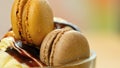 Vanilla ice cream macro closeup with chocolate sauce and macron cookies. Royalty Free Stock Photo