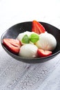 Vanilla ice cream with strawberries and almonds served in a plate Royalty Free Stock Photo