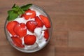 Vanilla ice cream with strawberries and mint in a glass bowl Royalty Free Stock Photo