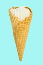 Vanilla ice cream in waffle cone isolated on pastel blue background, vertical close-up frame Royalty Free Stock Photo