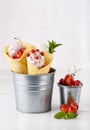 Vanilla ice cream in waffle cones decorated with various berries Royalty Free Stock Photo