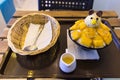 Vanilla lce cream with fresh mangoes,Decorated with bear head on black plate,With a glass of milk And spoon Basket
