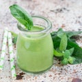 Vanilla, mint, spinach and coconut milk detox green smoothie in glass, square format Royalty Free Stock Photo