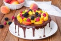 Vanilla mousse cake with peaches and chocolate glaze