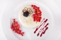 Vanilla panna cotta dessert with red currants and blackberries
