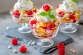 Vanilla peach dessert or melba ice cream with peach fruits. Colorful assortment of fruit salad topped with whipped cream Royalty Free Stock Photo