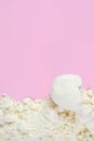 Vanilla protein powder scoop on pink background. Egg powder, soy and whey powder, casein supplements. Royalty Free Stock Photo