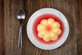 Vanilla pudding with strawberry sauce on wooden table Royalty Free Stock Photo