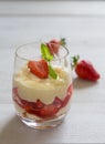 Vanilla pudding with tipsy strawberries on wood