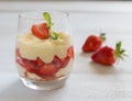 Vanilla pudding with tipsy strawberries on wood