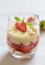 Vanilla pudding with tipsy strawberries on wood