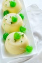 Vanilla puddings decorated with cocktail cherries