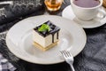 Vanilla souffle with dark chocolate glaze and cup of tea on black table Royalty Free Stock Photo