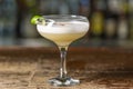 Vanilla Sour cocktail with egg white and lemon juice  on the bar. Blurred background Royalty Free Stock Photo