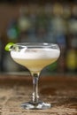 Vanilla Sour cocktail with egg white and lemon juice  on the bar. Blurred background Royalty Free Stock Photo