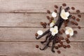 Vanilla sticks with coffee beans avd flower on a old wooden background with copy space for your text. Top view