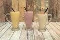 Vanilla, strawberry and mango smoothies served in glass jars Royalty Free Stock Photo