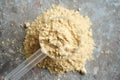 Vanilla whey protein powder in a measuring spoon Royalty Free Stock Photo