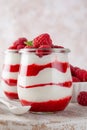 Vanilla white chocolate mousse, trifle, panna cotta or parfait with raspberry sauce in a glass jar. Sweet summer dieting dessert Royalty Free Stock Photo