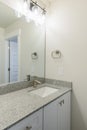Vanity sink of a bathroom with granite countertop and wall mounted lights Royalty Free Stock Photo